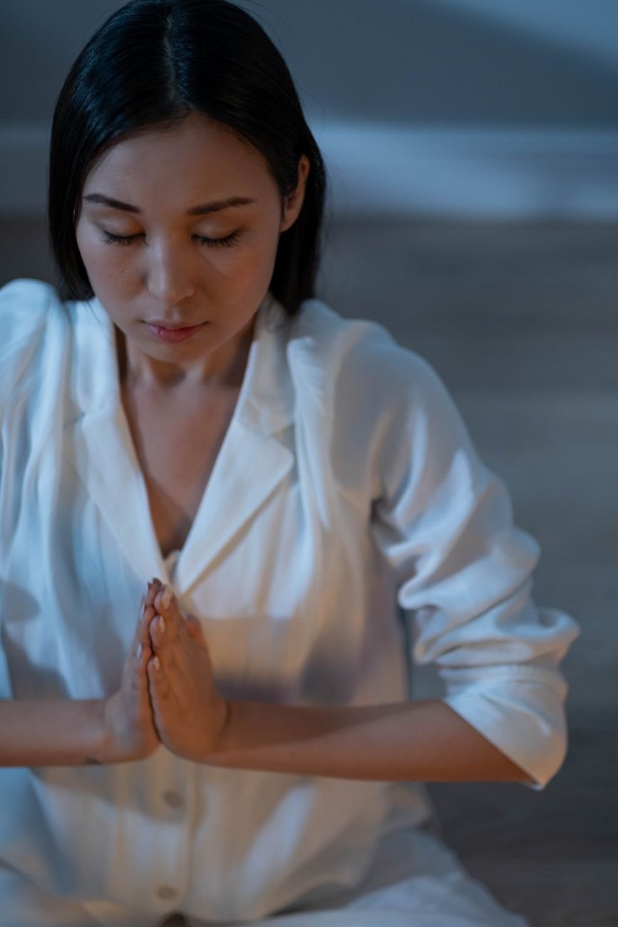 Serene portrait of a meditating woman with soft lighting