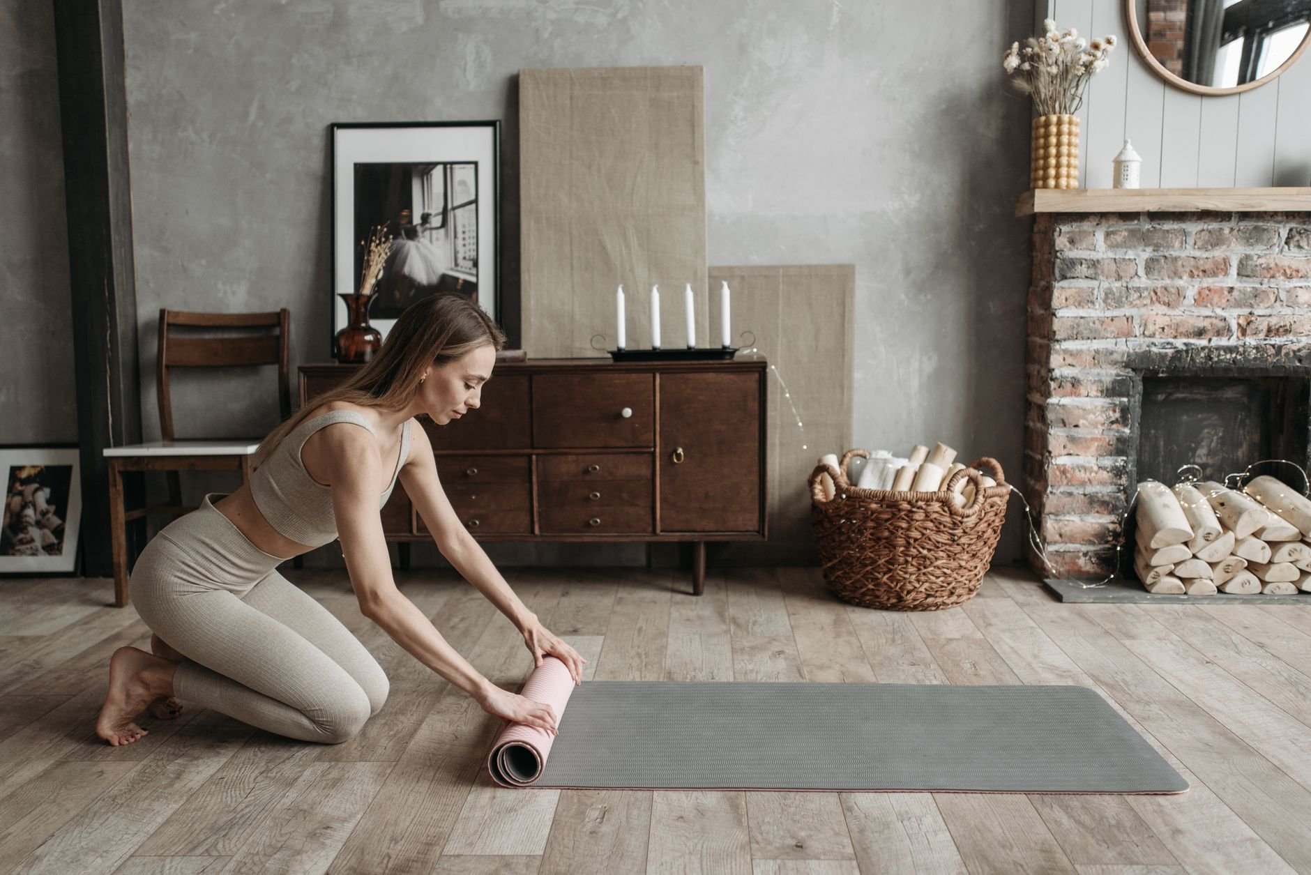 Woman preparing for a mindful workout session in a warm home setting